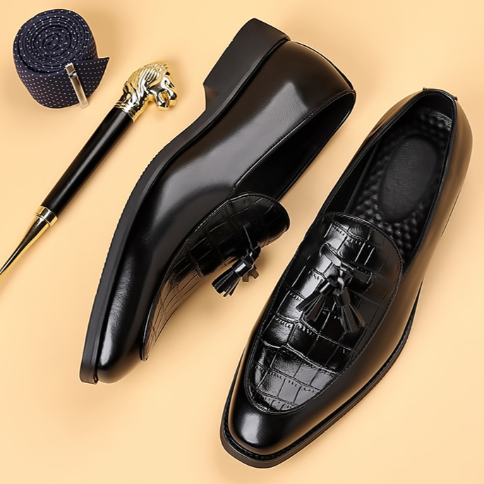 Comfortable men's polished leather tassel loafers; elegant slip-on formal shoes for classic style.