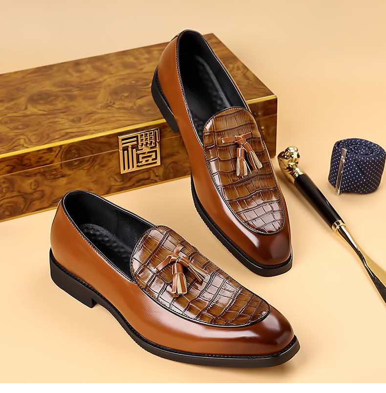 Elegant men's polished black tassel loafers, offering a sharp, classic look for formal or dress shoe occasions.