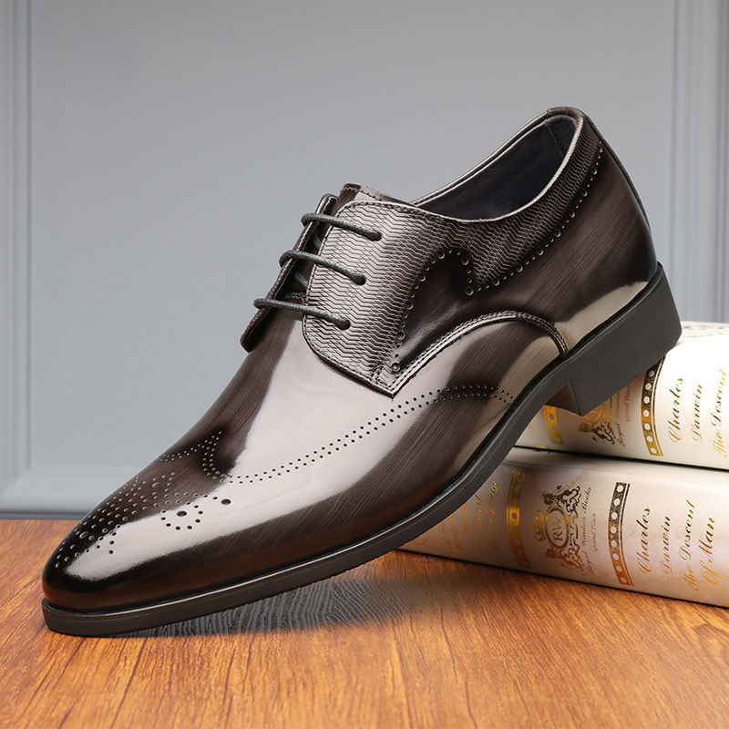 Top-down view of men's sleek black brogue oxford shoes, showcasing polished leather and classic design.