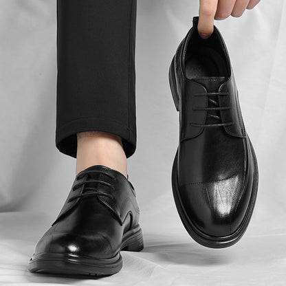 Detailed shot of the intricate brogue pattern on men's polished leather professional dress shoes.