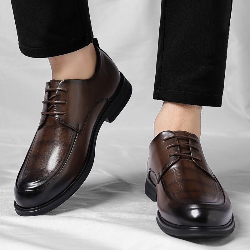 Elegant men's brown polished brogue dress shoes, featuring intricate brogue detailing for a sharp look.