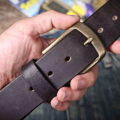 Backside of a durable men's brown cowhide leather belt. Classic leather accessory with quality finish.