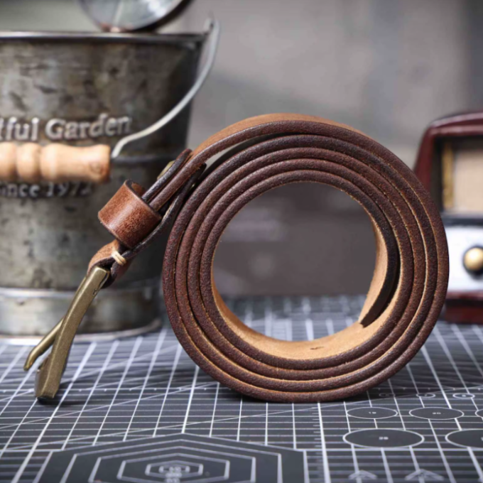 Tan men's cowhide leather belt. Classic, durable waist accessory in vintage style for a timeless look.