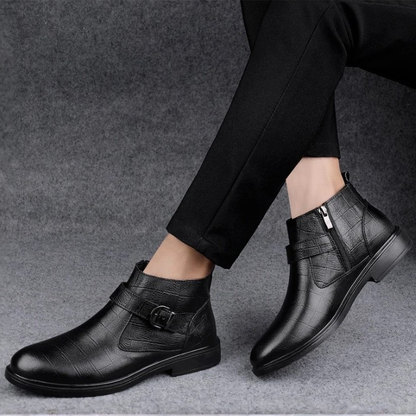 Front profile of black men's premium leather boots, highlighting rich texture, practical zipper, and classic buckle.