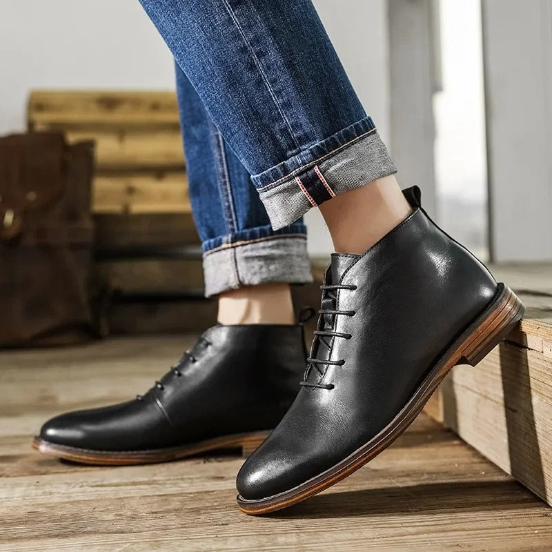 Men's black leather dress boots paired with a suit, embodying sharp formal footwear fashion.