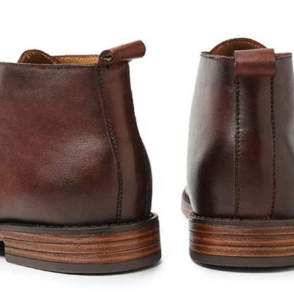 Elegant men's black dress boots in premium leather, essential formal footwear for modern fashion.
