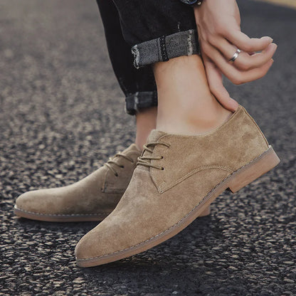 Man in suit wearing black suede Derby shoes, demonstrating their sharp dress shoe versatility.