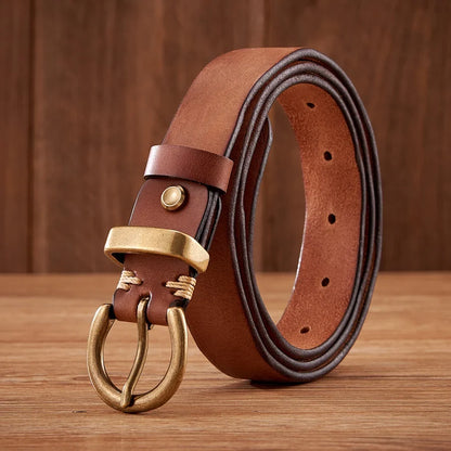 Detailed shot of a men's premium cowhide leather belt, showcasing its rich texture and the elegant brass buckle design.