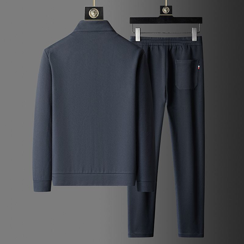 Athletic man jogging in a comfortable men's sportswear tracksuit. Two-piece activewear set for workouts & running.