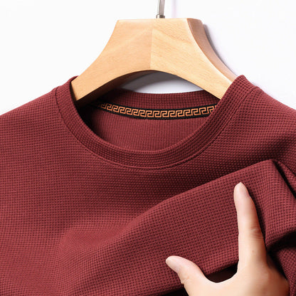 Detailed shot of premium textured fabric of men's short-sleeve t-shirt, emphasizing quality & comfort.