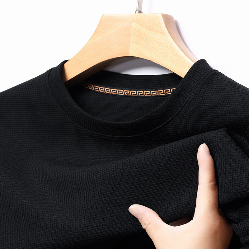 Close-up of men's premium textured short-sleeve t-shirt fabric, showcasing quality & everyday comfort.