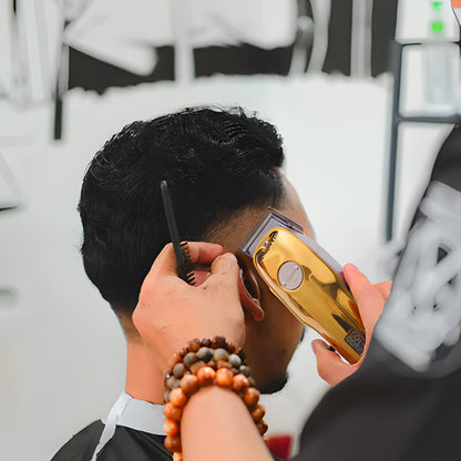 Stylish gold cordless hair clippers & trimmer, perfect barber tools for professional men's grooming.