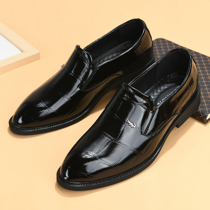 Close-up of men's modern slip-on loafers, showcasing premium leather texture & sleek professional design.
