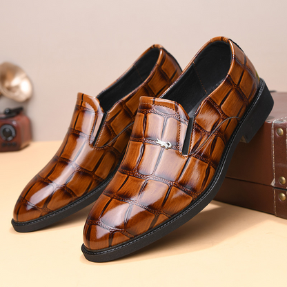 Modern mens formal loafers paired with a suit, creating a sharp & professional business look. Slip-on style.