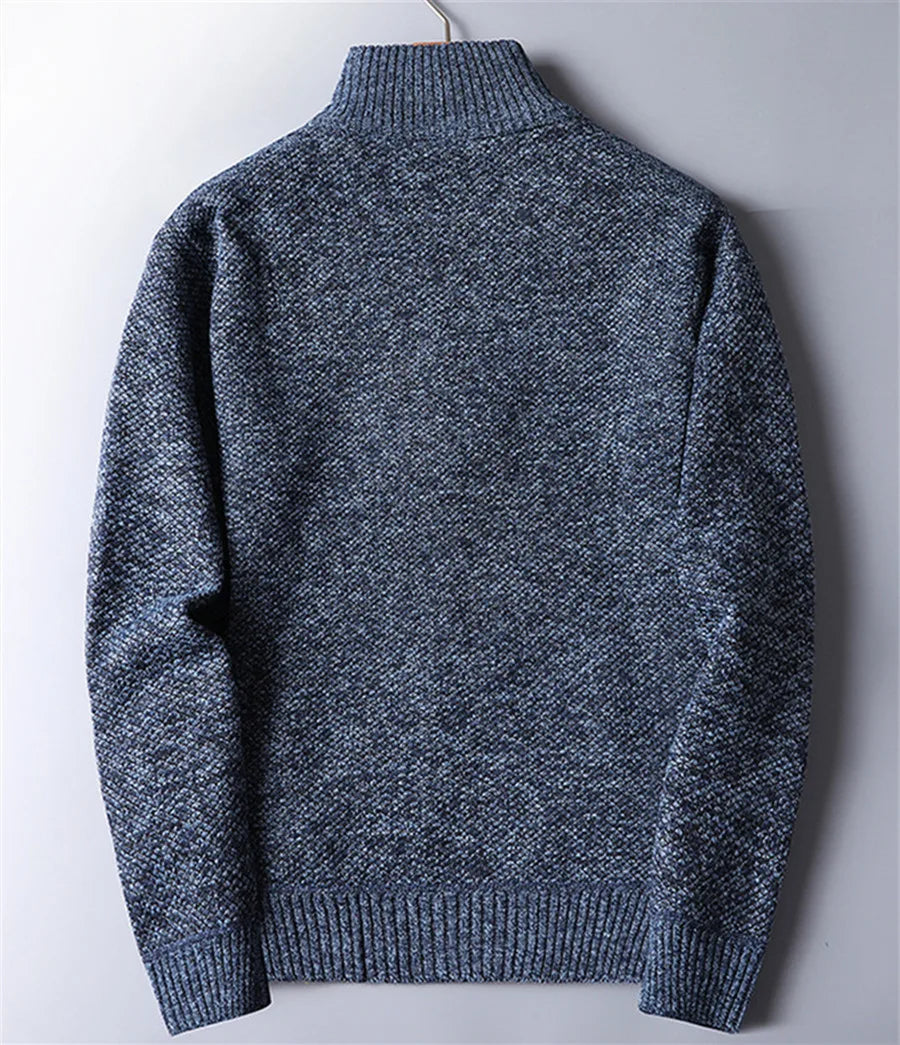 Warm, rugged knit fabric of men's quarter-zip turtleneck sweater, highlighting texture & quality.