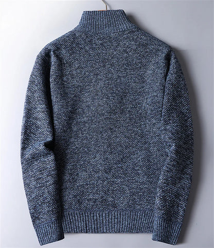 Warm, rugged knit fabric of men's quarter-zip turtleneck sweater, highlighting texture & quality.