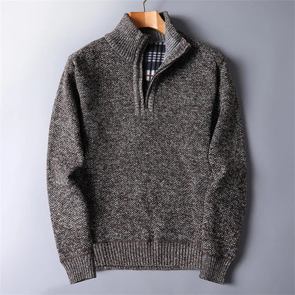 Folded men's quarter-zip turtleneck sweater, ready for layering or storage. Versatile winter top.