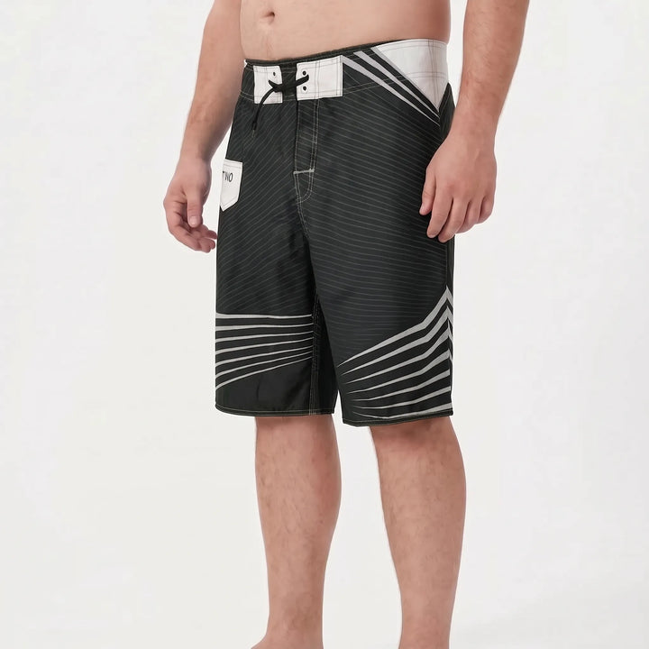 Relaxed fit men's quick-dry board shorts, perfect for summer fashion, beach lounging & casual swim.