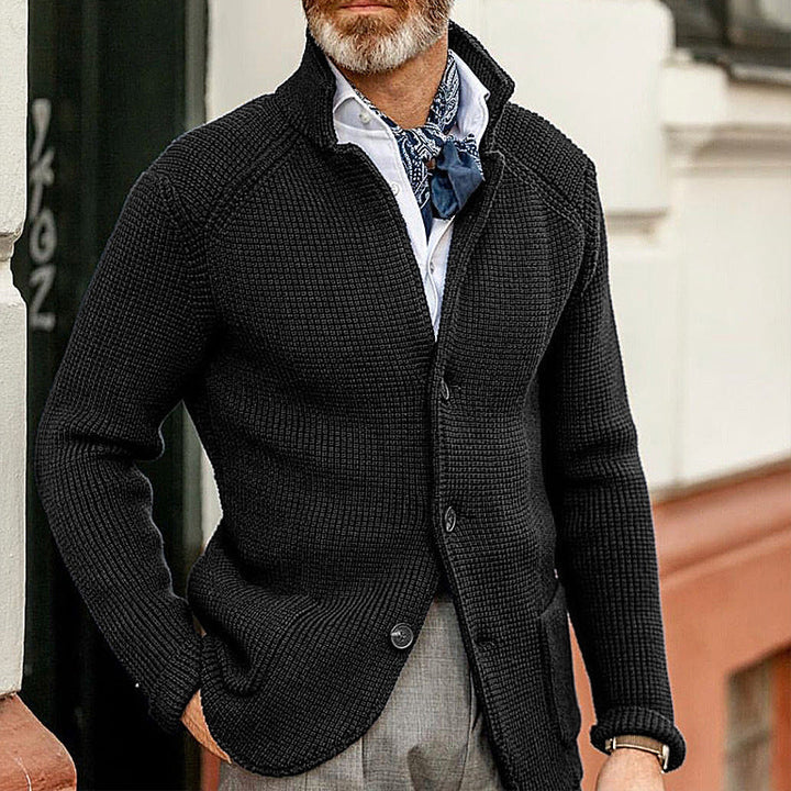 Close-up of a men's refined textured knit cardigan, highlighting the intricate autumn-winter fabric detail.