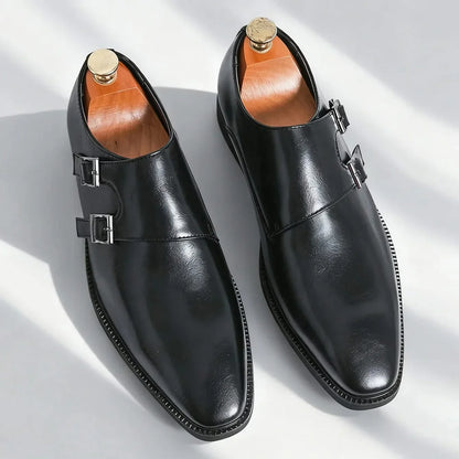Close-up of the shining double buckle on men's black leather Regent Monk Loafers, a detail of elegant design.
