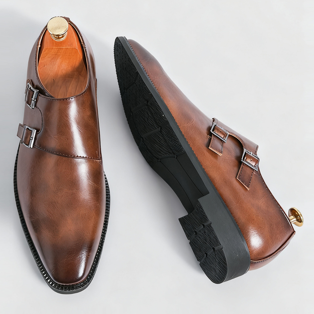 Elegant men's black leather monk strap loafers with gleaming double buckles, ideal for dress or professional settings.