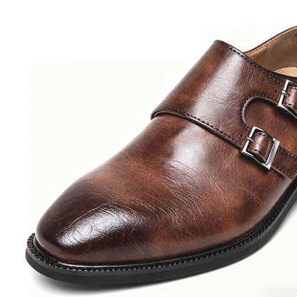 Front view of men's sleek black Regent Monk Loafers, highlighting the polished leather and double monk straps.