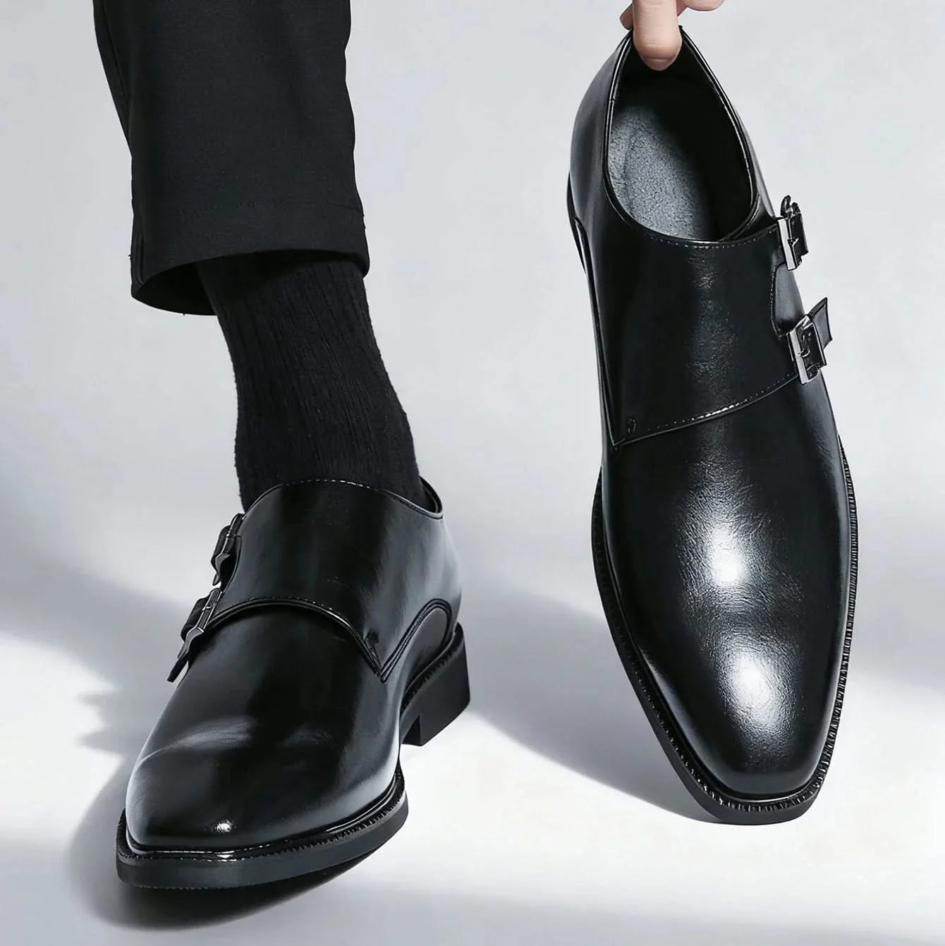 Side profile of men's comfortable Regent Monk Loafers. Black leather, elegant design with a durable sole.