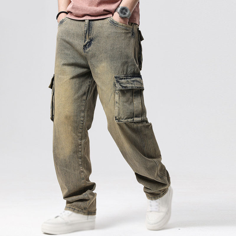 Men's relaxed fit cargo jeans, blue denim, with multiple deep utility pockets. Ideal for casual wear.