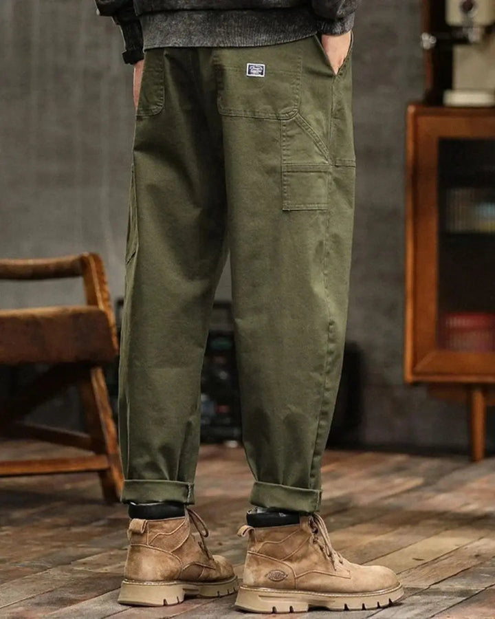 Army green men's relaxed fit cargo pants, ideal for outdoor adventures with utility pockets.
