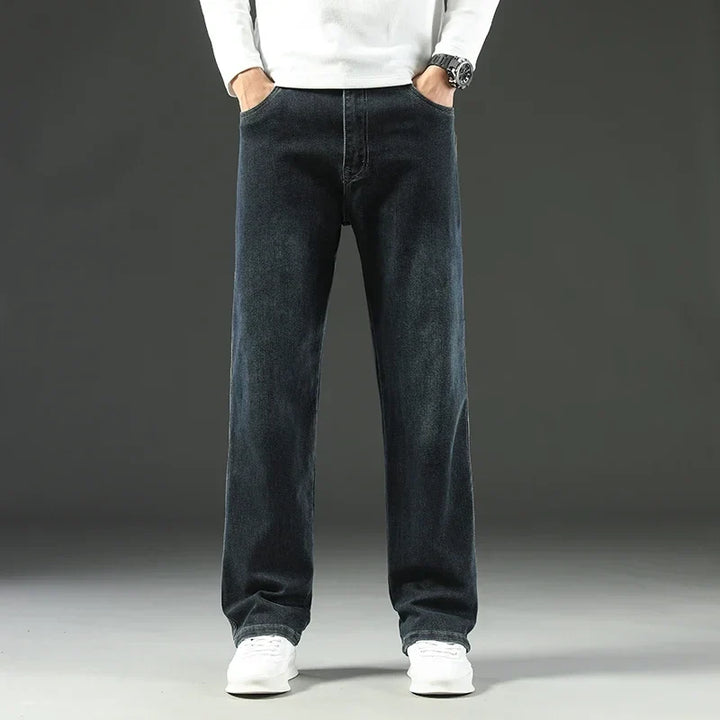 Close-up of durable men's carpenter jeans fabric, showing reinforced seams and practical utility pockets.