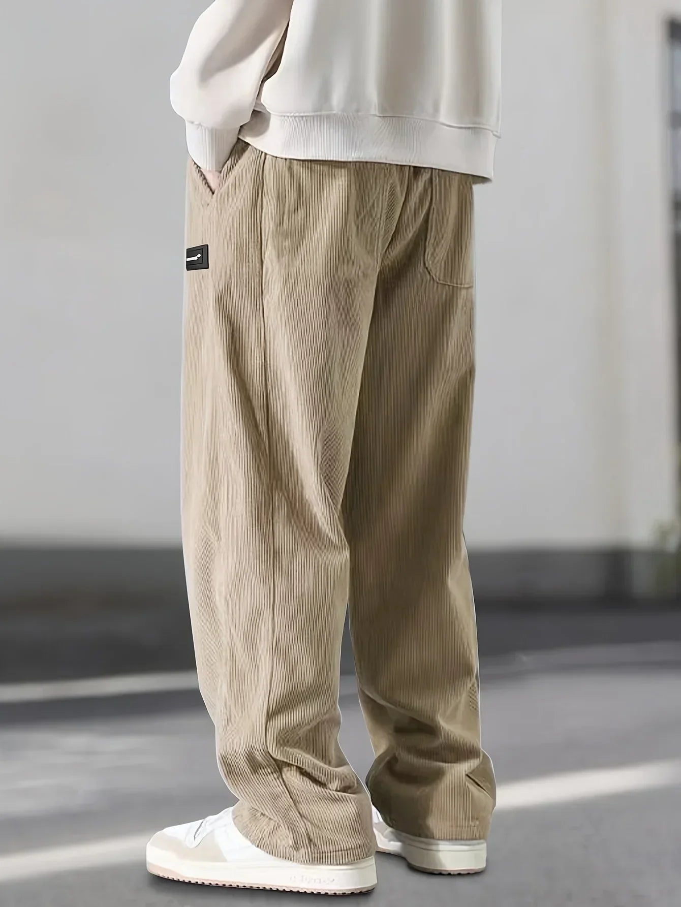 Modern men's fashion: grey relaxed fit casual trousers for a stylish everyday look.