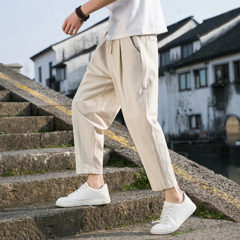 Versatile men's relaxed fit pants, perfect for semi-formal or casual wear. Comfortable drawstring design.