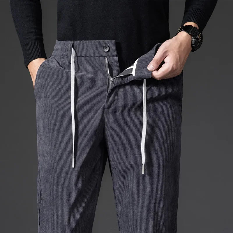 Close-up of comfortable men's relaxed fit pants, showing the fabric texture and drawstring detail.