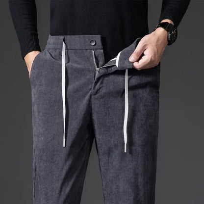 Close-up of comfortable men's relaxed fit pants, showing the fabric texture and drawstring detail.