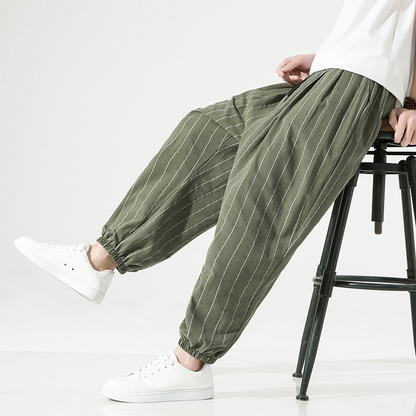 Close-up of drawstring waist on men's relaxed fit pinstripe harem joggers, a comfortable detail.