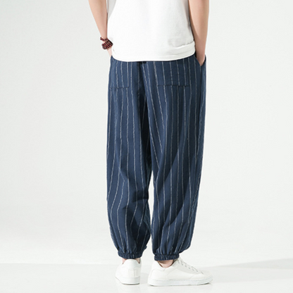 Detail shot of fabric texture on men's linen blend relaxed fit harem joggers, showing quality.