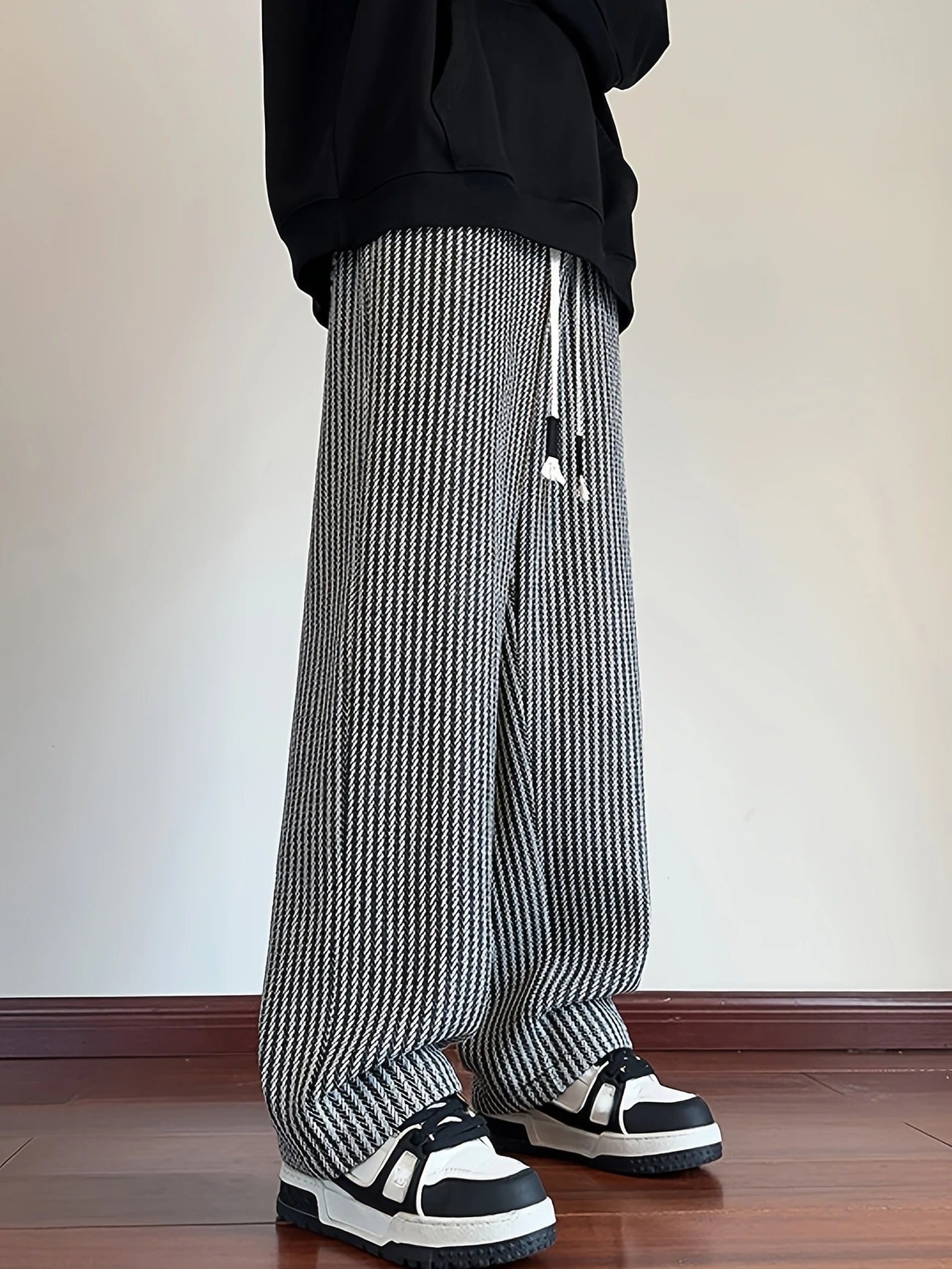 Drawstring waist men's relaxed fit lounge pants in a sophisticated herringbone design, versatile for casual outfits.