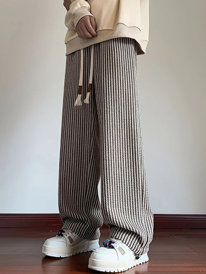 Relaxed fit men's casual pants with a distinctive herringbone design; comfortable for everyday lounging.