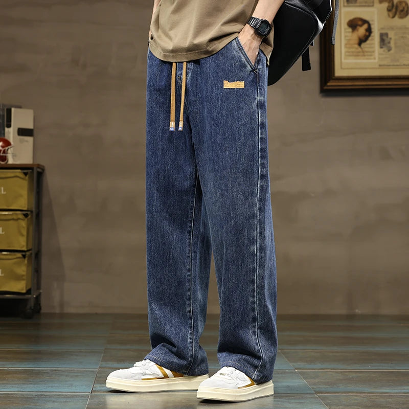 Men's relaxed fit indigo blue denim joggers with drawstring, perfect for comfortable everyday wear.
