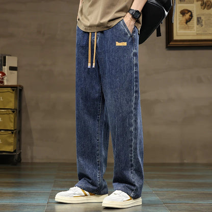 Men's relaxed fit indigo blue denim joggers with drawstring, perfect for comfortable everyday wear.