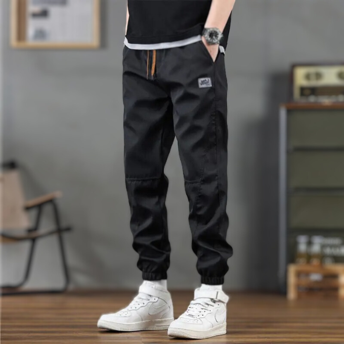 Men's grey relaxed fit tapered leg joggers, adjustable drawstring, soft polyester. Great for comfort & casual style.