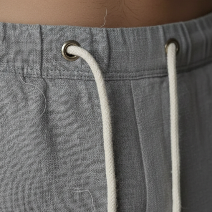 Stylish men's relaxed fit linen trousers with drawstring, ideal for warm weather.
