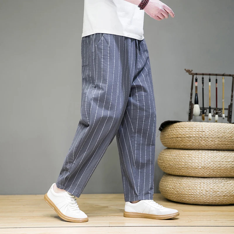 Man wearing comfortable men's relaxed pinstripe lounge pants, showcasing wide leg & casual style.