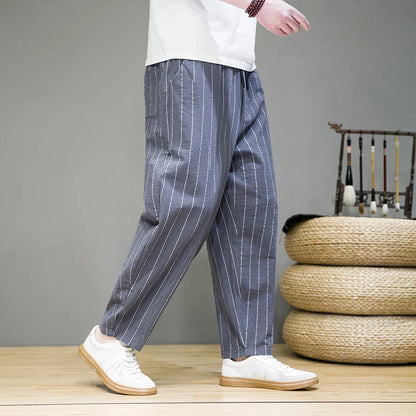 Man wearing comfortable men's relaxed pinstripe lounge pants, showcasing wide leg & casual style.