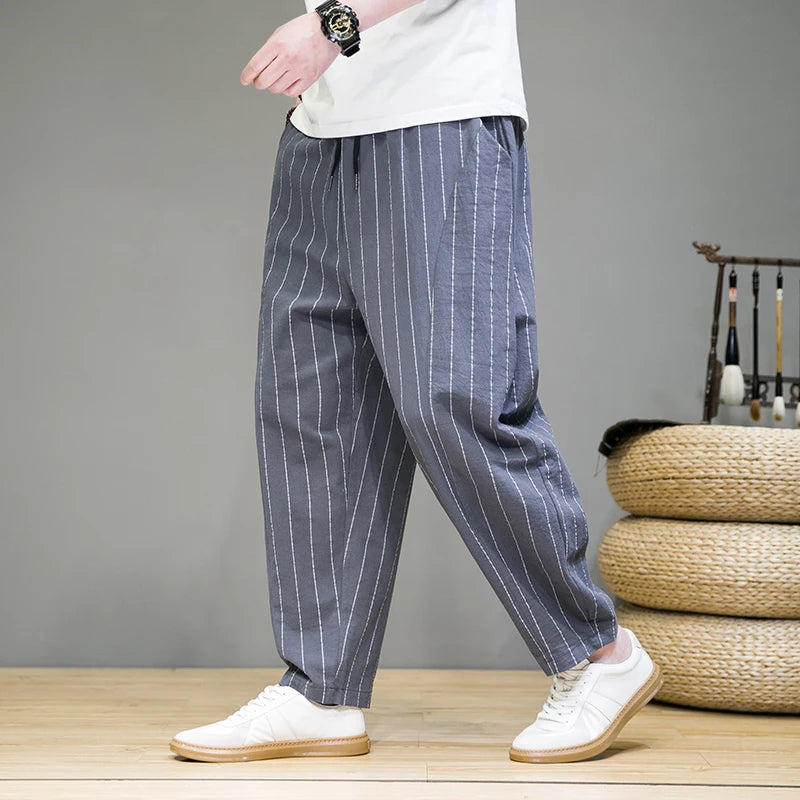 Full length view of men's relaxed fit pinstripe lounge pants. Comfortable, stylish, ideal for lounging.
