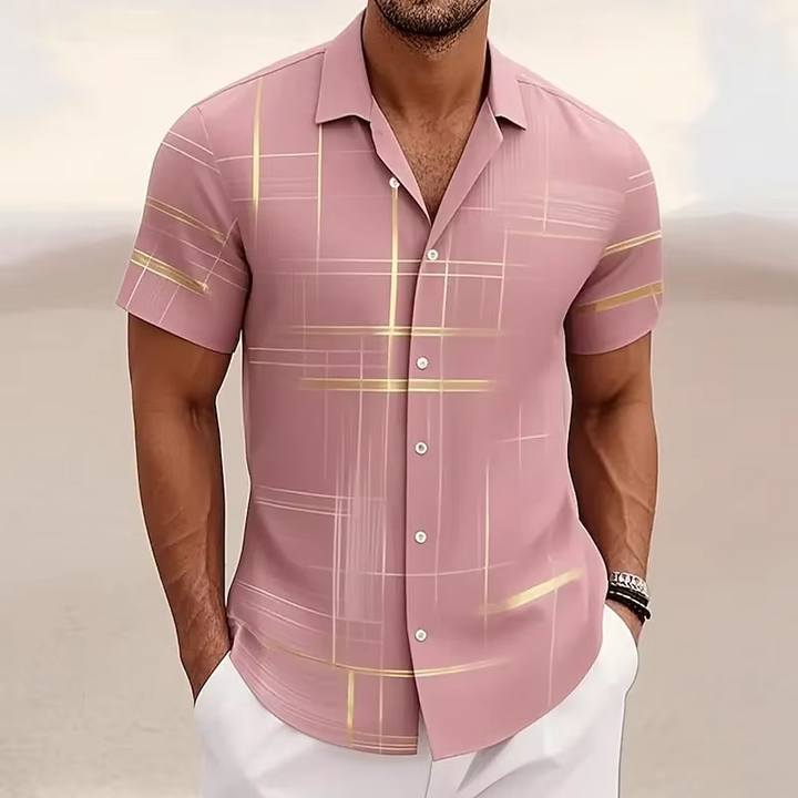 Man wearing a relaxed fit geometric print polo shirt, styled for a smart casual summer look.