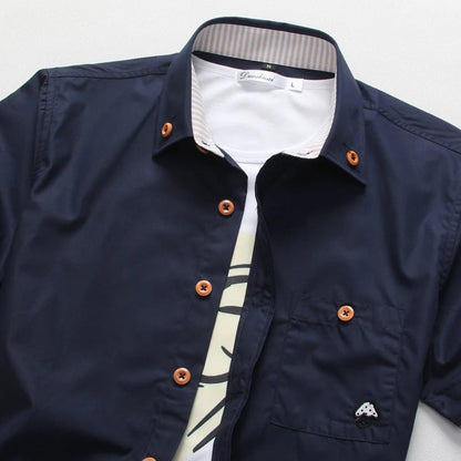 Man wearing a relaxed fit short sleeve button-up cotton shirt, looking stylish and ready for summer.
