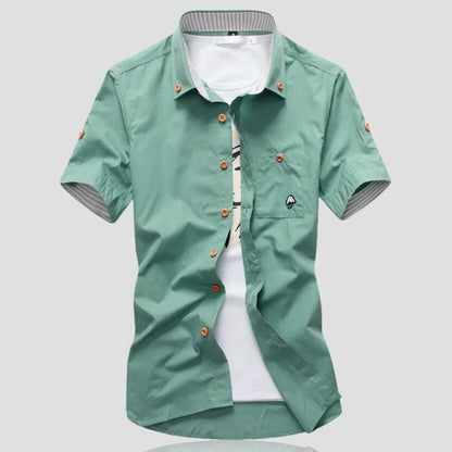Men's relaxed fit short sleeve button-up cotton shirt; a lightweight, breathable, and stylish summer essential.