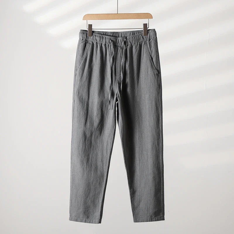 Back view of men's relaxed fit summer casual pants, featuring functional pockets for warm weather style.