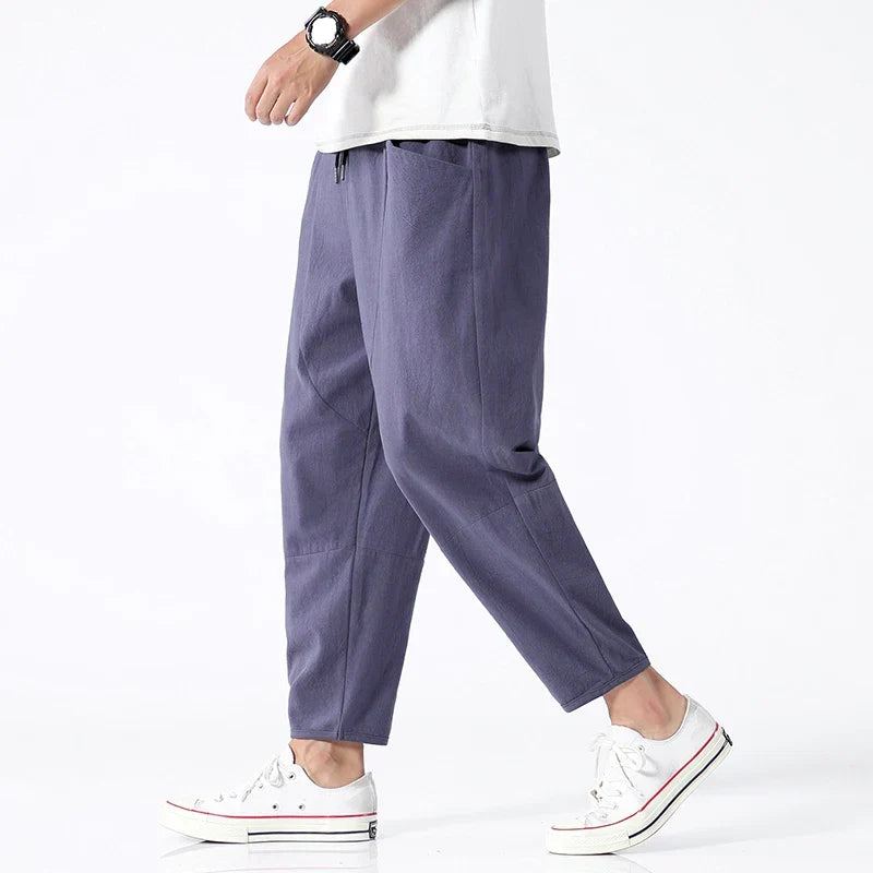 Men's relaxed fit tapered cropped pants in a modern style, ideal for casual everyday wear.